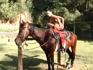 Tanned slut masturbating in front of her horse